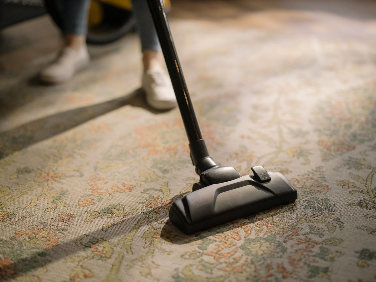 Vacuum head cleaning a patterned carpet.