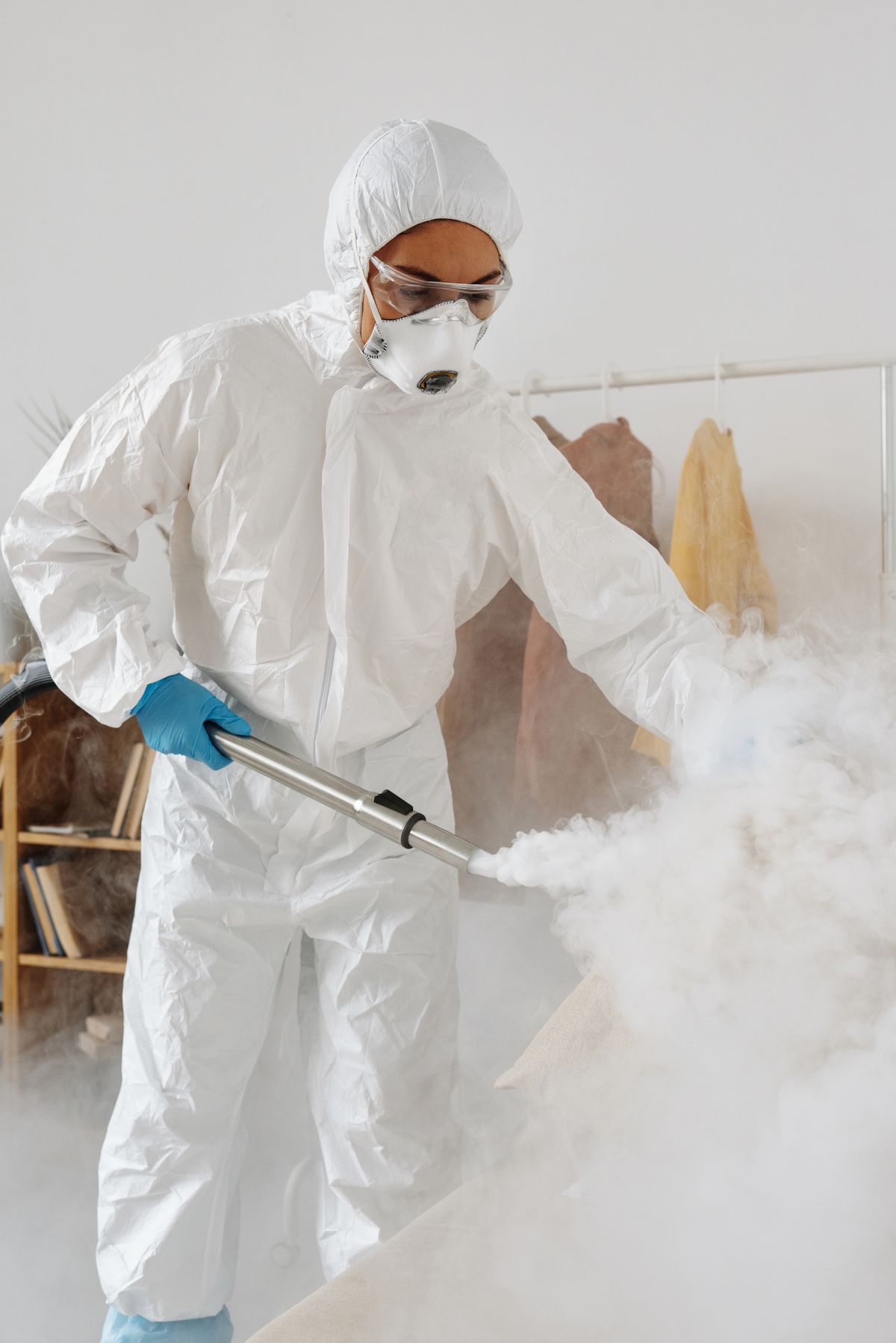 PPE-clad professional disinfecting an interior.
